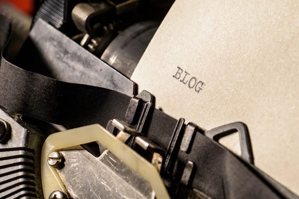 Blog typed words on a vintage typewriter.